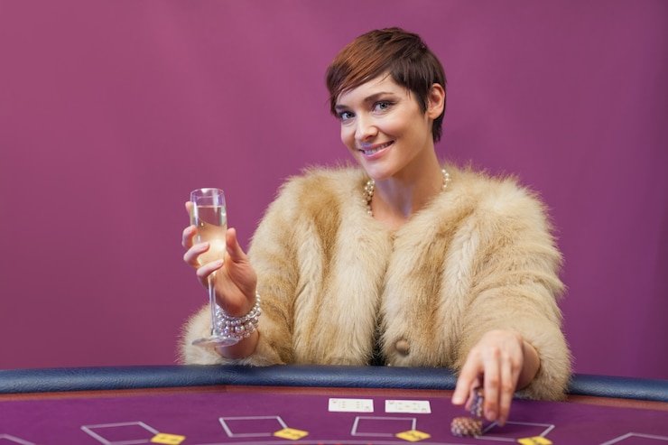 Pemain Baccarat sedang bermain di meja zeonslot dengan dealer profesional